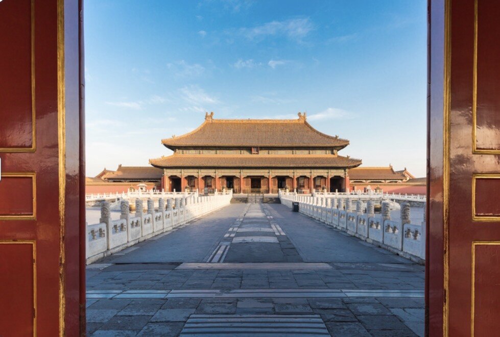 A grand courtyard of Beijing’s Forbidden City framed by red palace doors