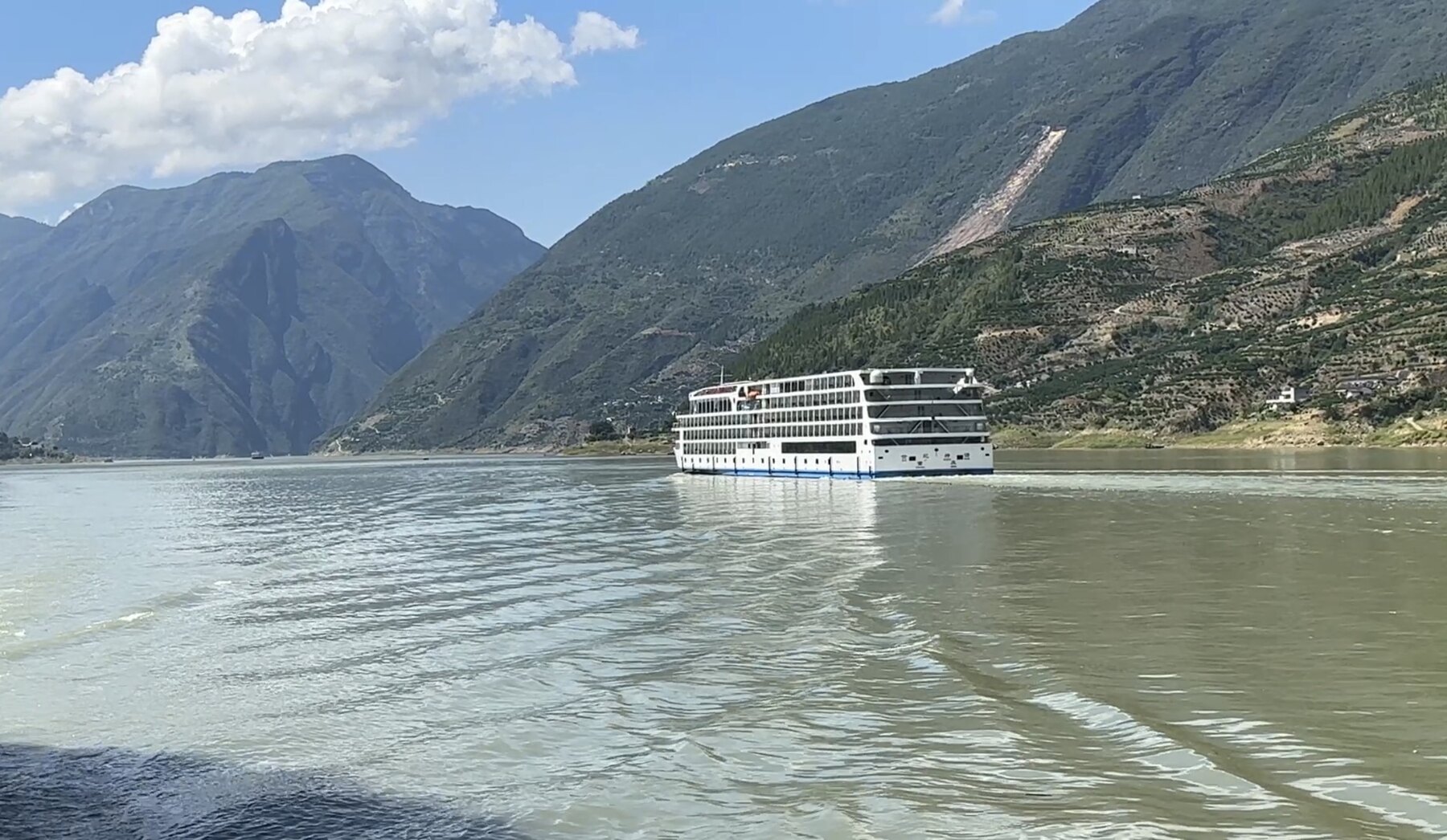A Century Cruising ship sailing through mountain scenery on the Yangtze River