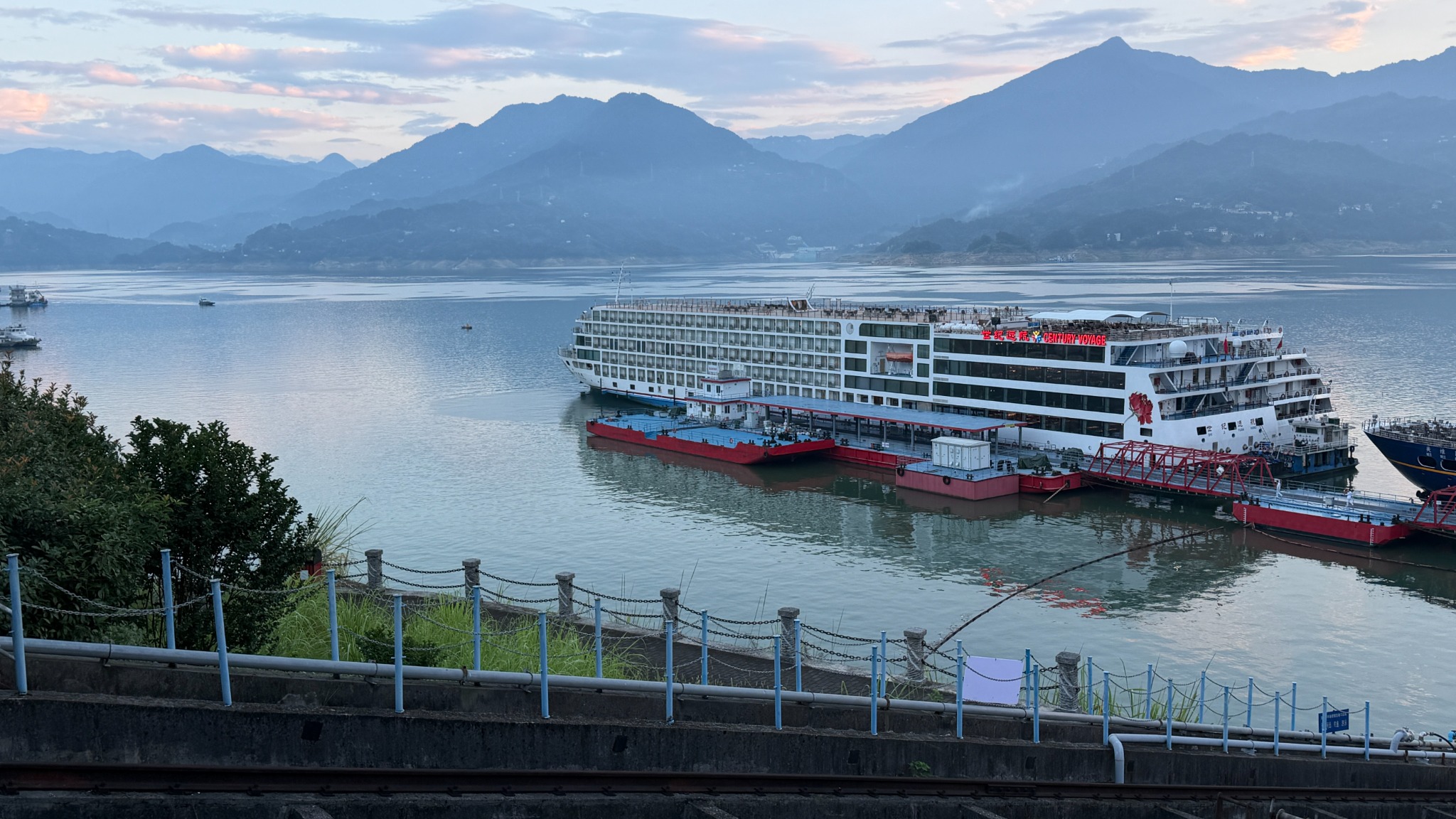 A river cruise ship on the Yangtze beneath mountain scenery