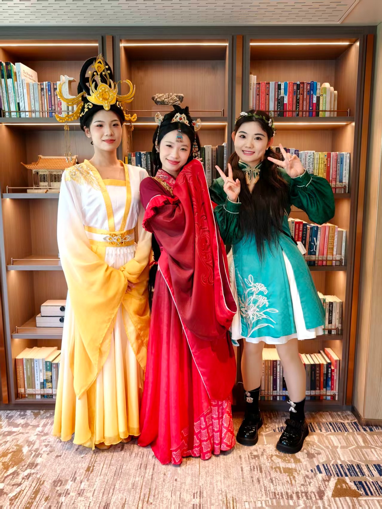 Three women wearing colorful traditional Chinese dress