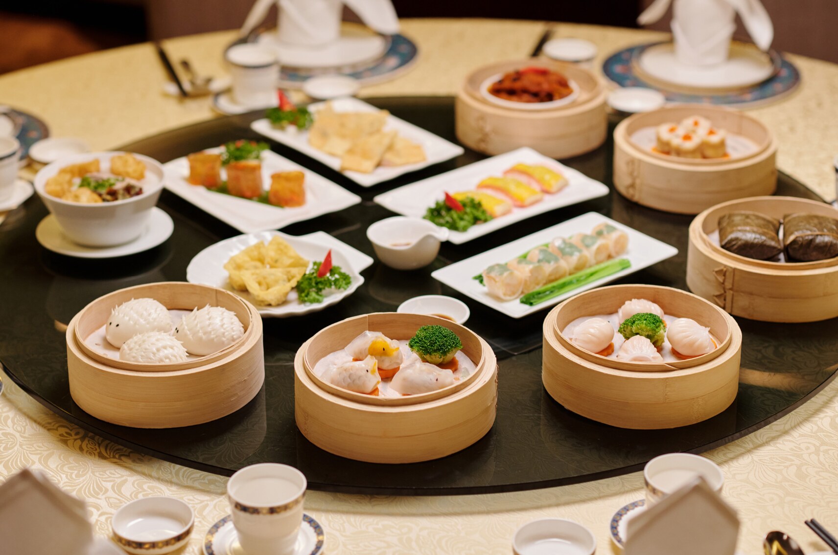 A generous shared table of colorful dim sum dishes