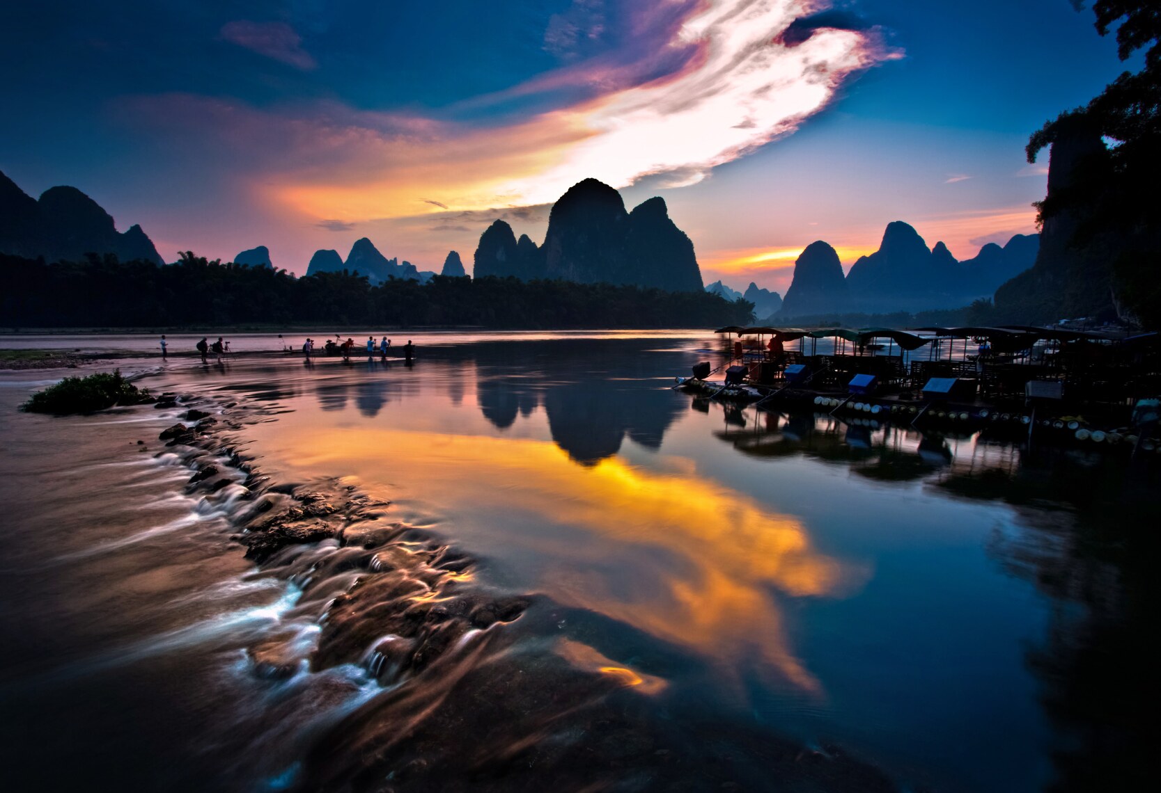 Guilin’s karst peaks reflected in the river at sunset