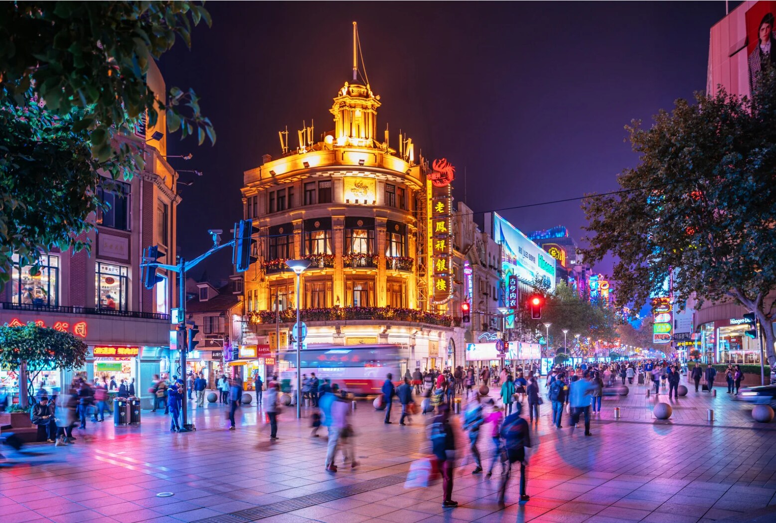 A lively pedestrian street in China filled with evening crowds and neon signs