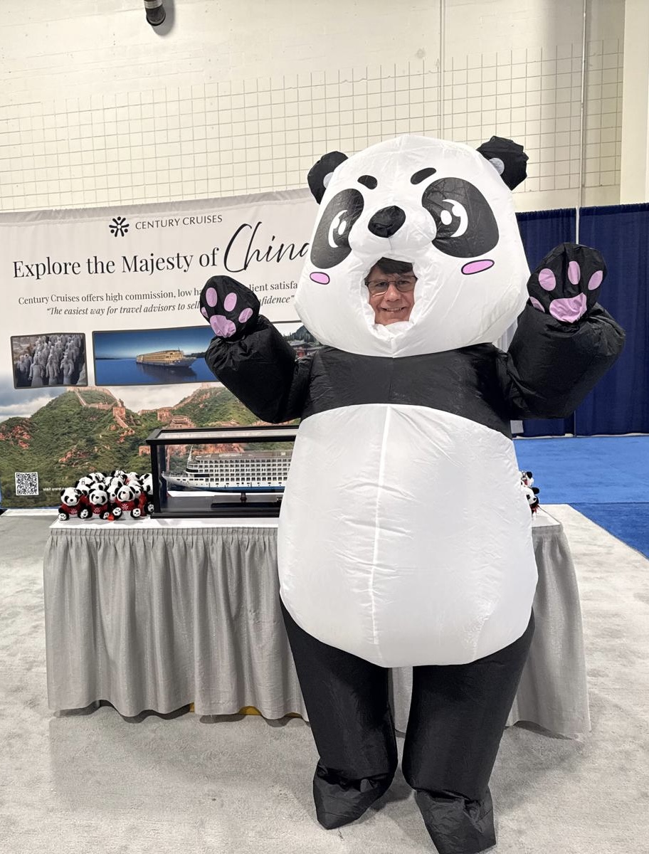 Steve wearing a giant panda costume during a China presentation