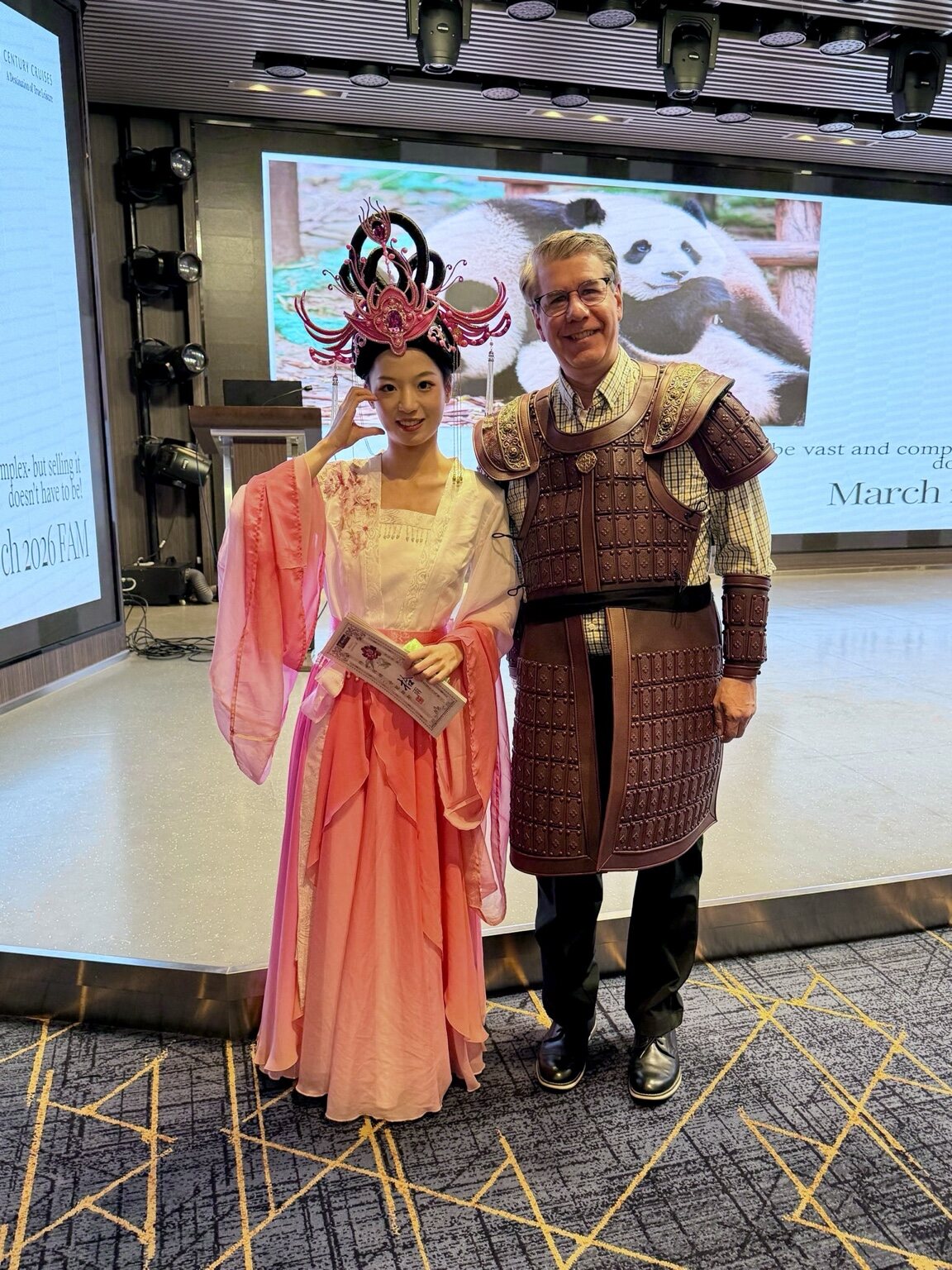 Steve wearing historical armor beside performers in traditional dress