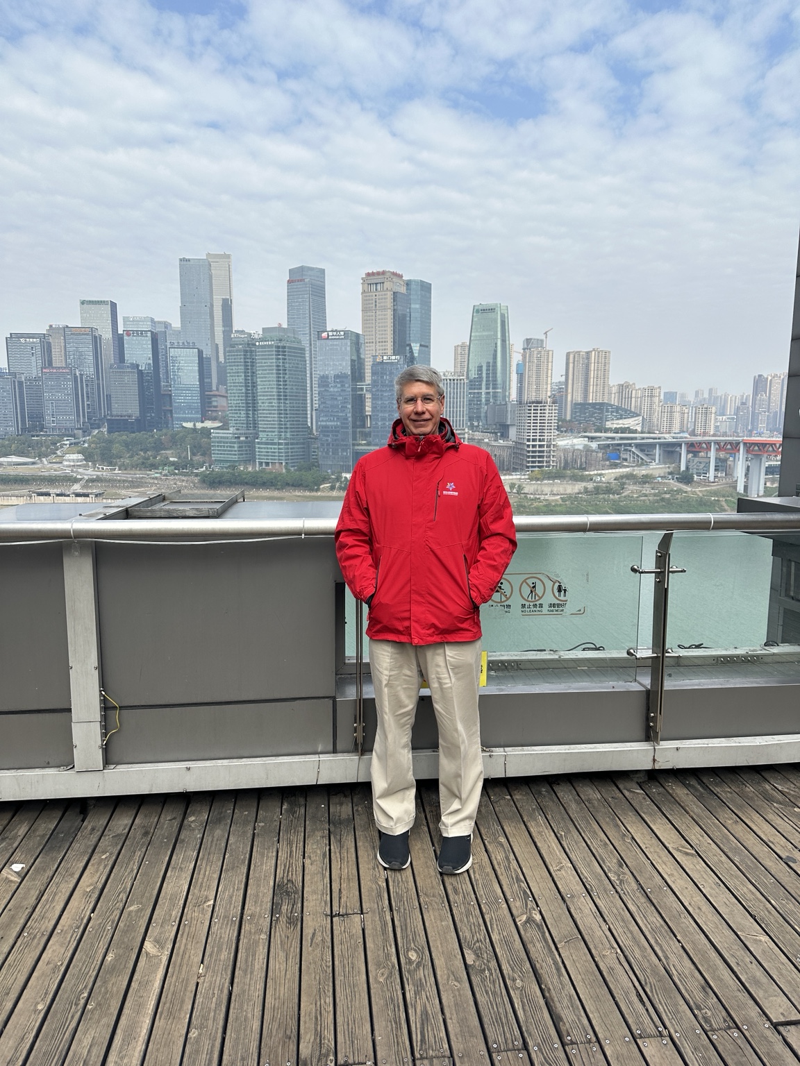 Steve aboard a ship with a Chinese city skyline beyond